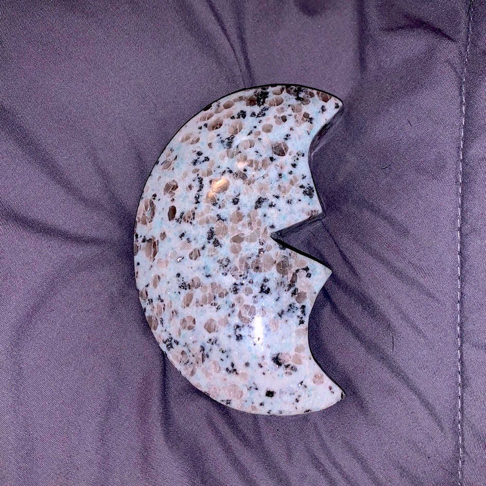a kiwi jasper half moon crystal.
